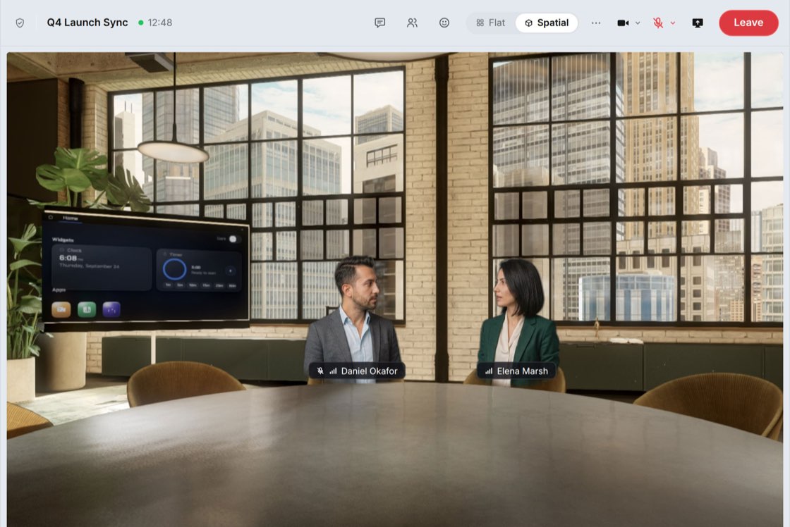 A spatial call in progress: two participants, Daniel Okafor and Elena Marsh, seated at a round table in a 3D loft meeting room with a wall display, and the call controls with Flat and Spatial views along the top.